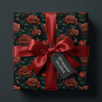Wrapped Studios luxury gift wrap with dark rose floral pattern and ruby red satin bow.