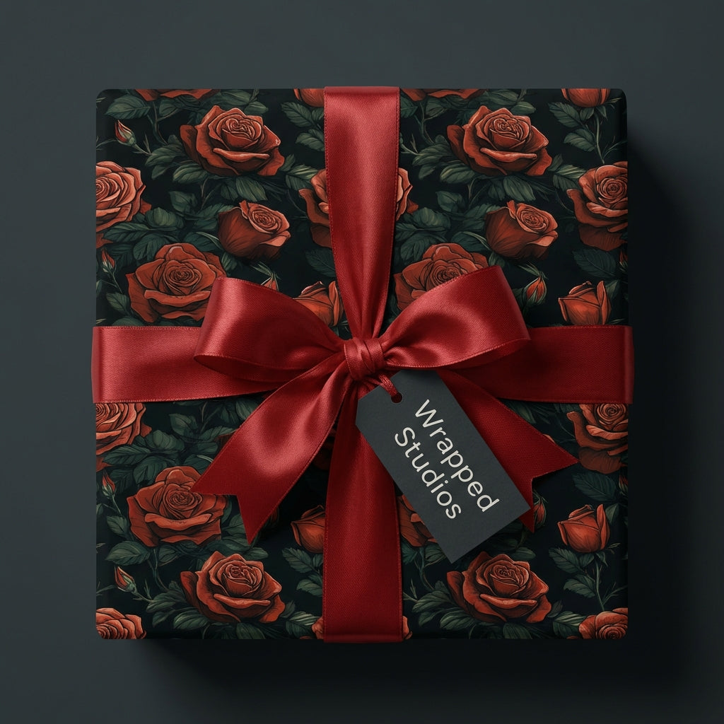 Wrapped Studios luxury gift wrap with dark rose floral pattern and ruby red satin bow.