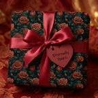 Elegant floral wrapping paper with red roses, satin ribbon, and heart tag. Wrapped Studios.