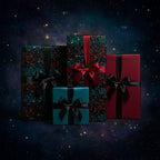 Luxury Christmas gift wrap with galaxy-patterned paper, red/black satin ribbons on square and rectangular boxes against a starry background.