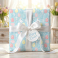 Christian Easter wrapping paper with crosses and pastel eggs, tied with a white bow by Wrapped Studios.