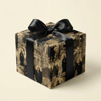 Square gift wrapped in vintage-style paper with religious figures and architecture, tied with a black satin bow.