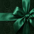 Elegant emerald green gift wrap with matching satin ribbon bow.