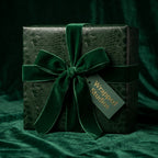 Wrapped Studios luxury gift wrap: Emerald green reptile print with velvet ribbon bow.