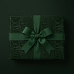 Dark green luxury gift wrap with crocodile texture and ribbon bow.