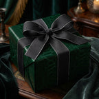 Luxury gift wrapped in dark green faux alligator paper with a black ribbon bow from Wrapped Studios.