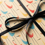Retro bird wrapping paper with mid-century crane pattern and black satin ribbon, by Wrapped Studios.