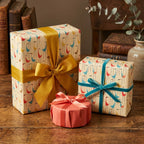 Retro mid-century modern bird wrapping paper on gifts with satin and velvet ribbons by Wrapped Studios.