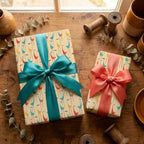 Mid-century modern bird wrapping paper with teal and coral bows by Wrapped Studios.