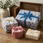 Blue daisy floral wrapping paper with luxury velvet ribbon on gift boxes by Wrapped Studios.