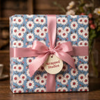 Vintage blue daisy floral wrapping paper with pink satin ribbon bow by Wrapped Studios.