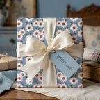 Vintage blue floral wrapping paper with white daisies and cream satin bow by Wrapped Studios.