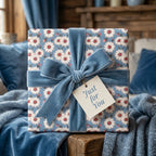 Blue daisy floral wrapping paper with a luxury velvet ribbon and gift tag by Wrapped Studios.