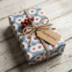 Vintage blue daisy floral wrapping paper on a gift box with rustic twine and tag by Wrapped Studios.