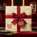 Popcorn movie night wrapping paper with a red ribbon and tag by Wrapped Studios.