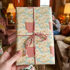 Popcorn wrapping paper with red and white baker's twine on a birthday gift box, by Wrapped Studios.