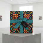 Retro geometric wrapping paper with teal ribbon, tied on a square gift box with a tag.