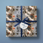 Cute robot wrapping paper with hearts, a blue ribbon, and gift tag by Wrapped Studios.