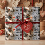 Valentine's Day robot wrapping paper with a red ribbon and heart tag by Wrapped Studios.