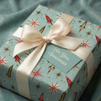 Retro space wrapping paper with vintage rocket ships and cream satin ribbon by Wrapped Studios.