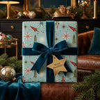 Mid-century modern Christmas wrapping paper with retro rocket pattern and teal velvet bow by Wrapped Studios.