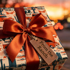 Rustic western wrapping paper with vintage red trucks and a satin bow by Wrapped Studios.