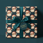 Luxury teal Christmas gift wrap with vintage Santa pattern and a satin bow, by Wrapped Studios.
