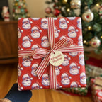 Vintage Santa Christmas wrapping paper with striped ribbon, by Wrapped Studios.