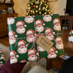 Vintage Santa Claus Christmas wrapping paper tied with red and white twine, by Wrapped Studios.