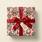 Afrocentric birthday wrapping paper with a red satin ribbon by Wrapped Studios.
