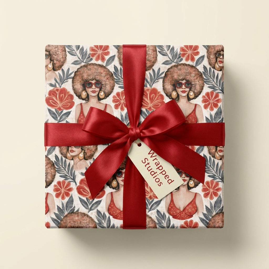 Afrocentric birthday wrapping paper with a red satin ribbon by Wrapped Studios.
