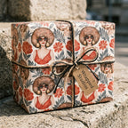 70s retro wrapping paper with Afro illustrations and red flowers on a gift box by Wrapped Studios.