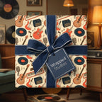 Retro music gift wrap with guitars and vinyl records, tied with a navy blue ribbon by Wrapped Studios.