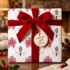 Vintage Christmas wrapping paper with red bow pattern and a luxury velvet ribbon by Wrapped Studios.