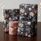 Luxury Christmas gift wrap with a dark floral and ornament pattern, tied with elegant grey and rose gold ribbons on a wooden table.