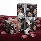 Elegant Christmas floral wrapping paper on dark background with rose gold roses, silver ornaments, and silver and rose gold ribbons.