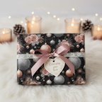 Elegant dark floral Christmas wrapping paper with rose gold and silver ornaments, a pink ribbon, and a heart-shaped "Celebrating your love" tag on a white fur rug.