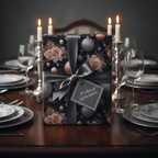 Elegant black floral Christmas wrapping paper with pink roses and silver ornaments, tied with a grey satin ribbon and a gift tag, on a formal dining table with lit candles.