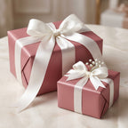 Elegant dusty rose wrapping paper with white satin ribbon for birthday, wedding, or baby shower gifts.