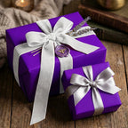 Elegant purple wrapping paper with silver velvet ribbon and bee wax seal for luxury gift packaging.