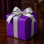 Elegant purple gift box wrapped in silver ribbon, perfect for birthdays or special occasions.