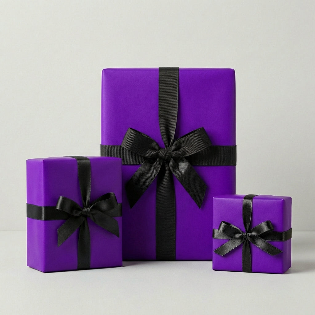 Three square gift boxes wrapped in bright purple paper with elegant black ribbon and bows.