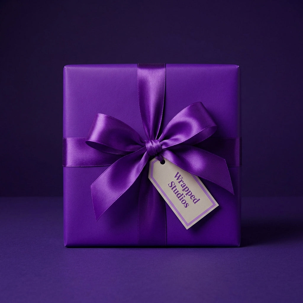 Elegant square gift wrapped in purple paper with satin ribbon, perfect for birthdays or celebrations.