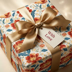 Luxury vintage floral wrapping paper with gold satin bow and "With Love" tag by Wrapped Studios.