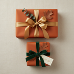 Burnt orange gift wrap with gold and green velvet ribbon, oak leaf, and "With Love" tag for autumn or holiday gift giving.