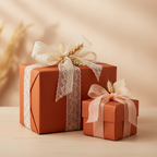 Two gifts wrapped in solid rust paper with lace and sheer ribbon, and wheat accents.