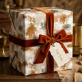 Rustic luxury wrapping paper with earthy abstract print and rust velvet bow by Wrapped Studios.
