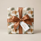 Modern abstract luxury gift wrap in earthy terracotta and green with a brown satin bow by Wrapped Studios.