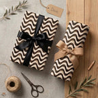 Modern wavy wrapping paper in black and cream with elegant bows by Wrapped Studios.