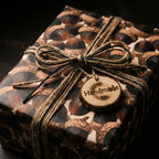 Rustic acorn wrapping paper with twine bow and handmade wooden tag by Wrapped Studios.
